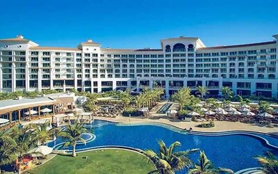 Beautiful outdoors with garden and pool at the Waldorf Astoria Dubai Palm Jumeirah.