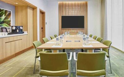 Meeting room with square conference table at the Hilton Garden Inn Dubai Mall of the Emirates.