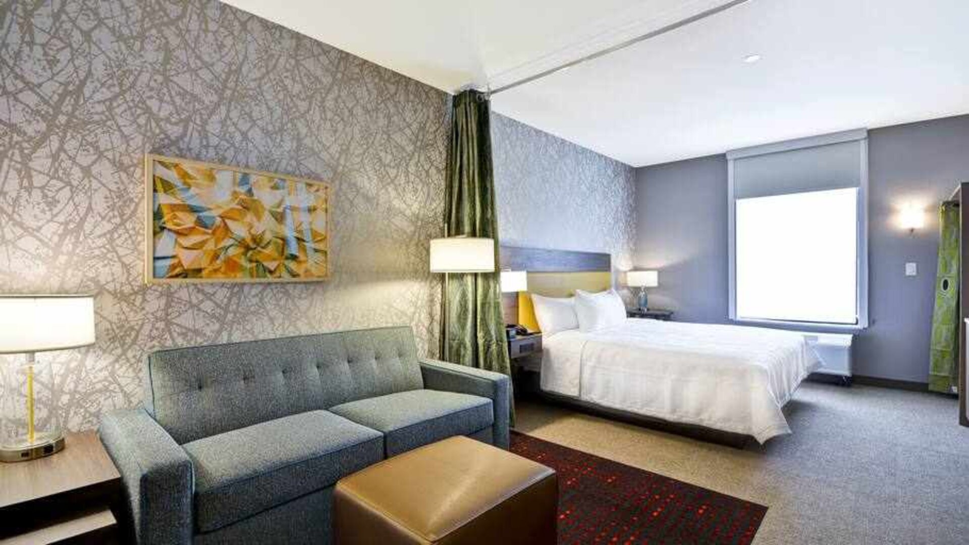 Spacious king size bed with workspace and living area at the Home2 Suites by Hilton Fairview/Allen.