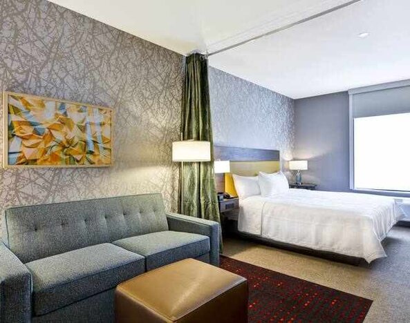 Spacious king size bed with workspace and living area at the Home2 Suites by Hilton Fairview/Allen.