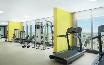 Spacious gym with workout equipment and large windows