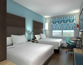 Double king beds with work desk area at Tru by Hilton Edinburg.