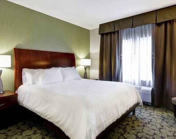 Comfortable king bed in a hotel bedroom at the Hilton Garden Inn Fort Collins.