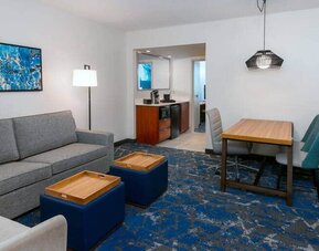 Spacious living area attached to kitchen at the Embassy Suites by Hilton Tampa USF