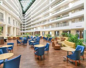 Beautiful and bright outdoor workspace with sofas and chairs at the Embassy Suites by Hilton Alexandria-Old Town.