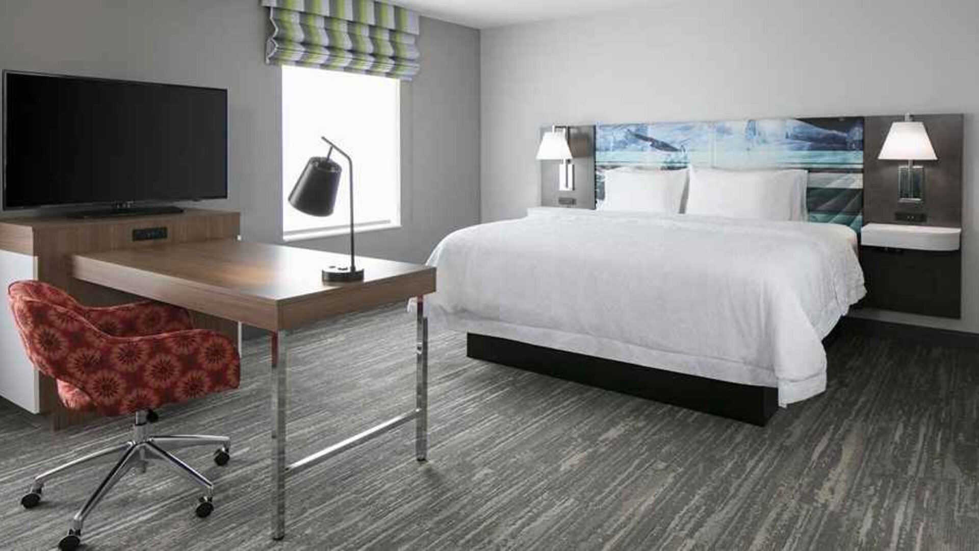 delux king-sized bed with work desk at Hampton Inn Wichita Northwest.