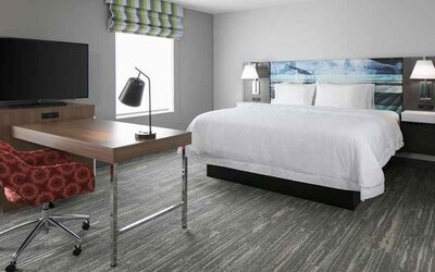 delux king-sized bed with work desk at Hampton Inn Wichita Northwest.