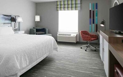 spacious king-sized room with TV and workspace at Hampton Inn Wichita Northwest.