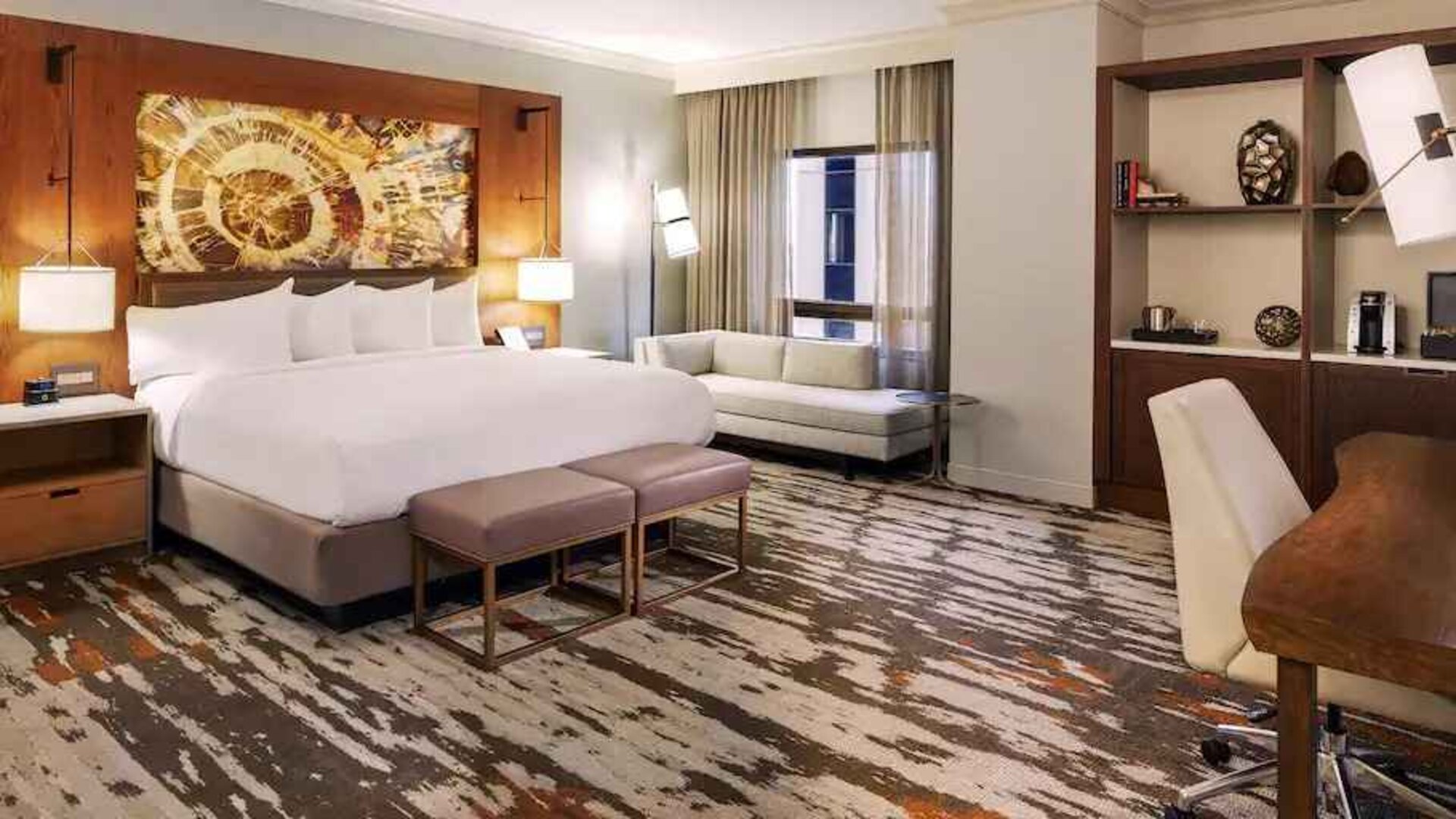 Stunning presidential bedroom with king size bed, sofa and working station at the Hilton Denver City Center.