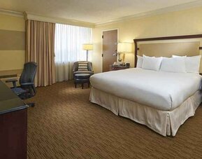 spacious king room equipped with work desk and natural light at Hilton Raleigh North Hills.