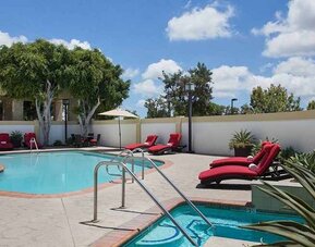 beautiful, outdoor pool with tanning beds and seating at DoubleTree by Hilton Los Angeles - Norwalk.
