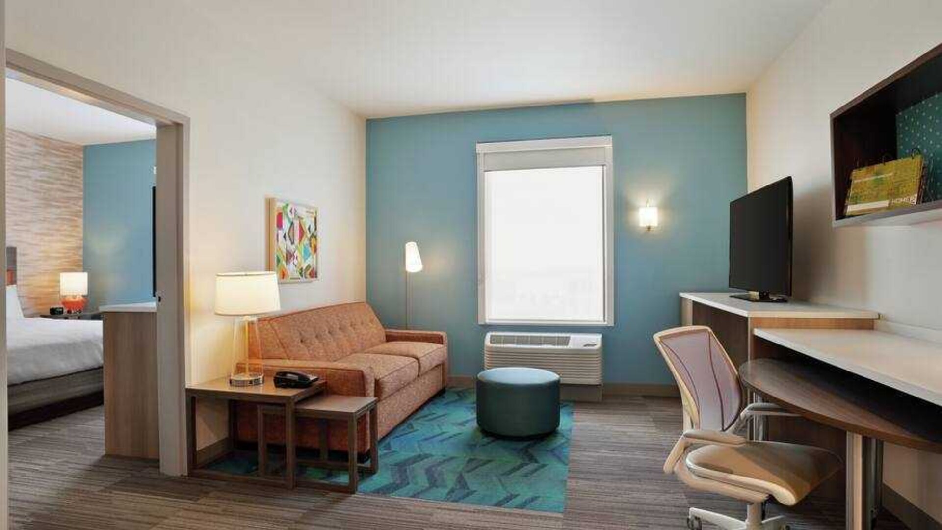 Living room in a king suite with working station at the Home2 Suites by Hilton Warminster Horsham.