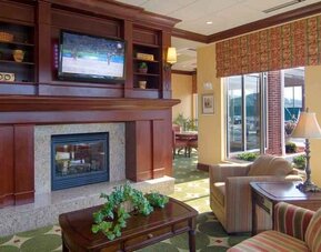 Elegant lobby area with fireplace and TV at the Hilton Garden Inn Clarksburg.