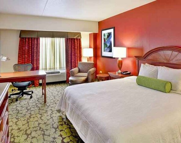 Beautiful king suite with TV, work desk, and lounge area at Hilton Garden Inn Chicago/Midway Airport.
