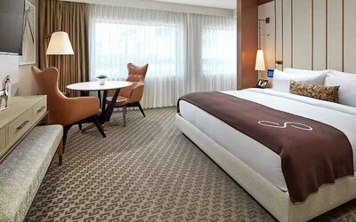 Comfortable king deluxe room with desk and window at the Statler Dallas, Curio Collection by Hilton.