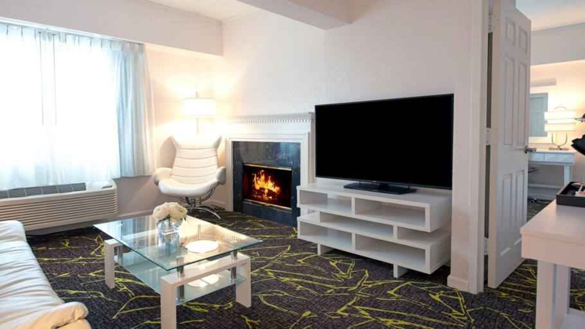 Beautiful hotel suite with fireplace at the The Roslyn, Tapestry Collection by Hilton.