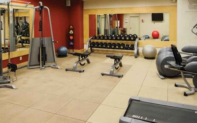 Fitness center with weights and machines at the DoubleTree by Hilton Omaha-Downtown.