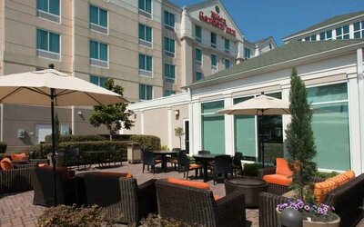 Outdoor patio area with lounges and tables perfect as workspace at the Hilton Garden Inn Tallahassee Central.