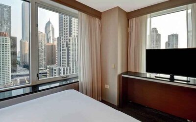 King guestroom with city view at the Embassy Suites by Hilton Chicago Magnificent Mile.