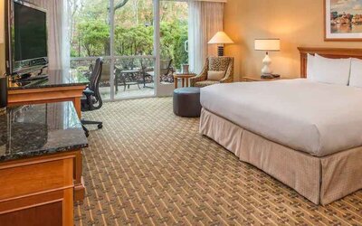 Spacious and comfortable king suite with balcony at the Hilton Seattle Airport & Conference Center.