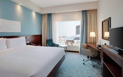 King suite with queen bed, desk, tv, wifi and other amenities at the Hampton by Hilton Dubai al Barsha