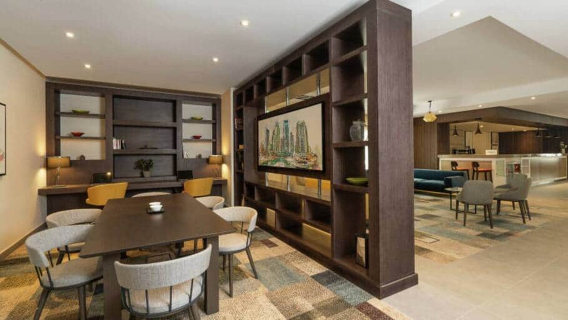 Spacious work lounge area in the lobby with large wooden bookshelves making for cozy partitions.