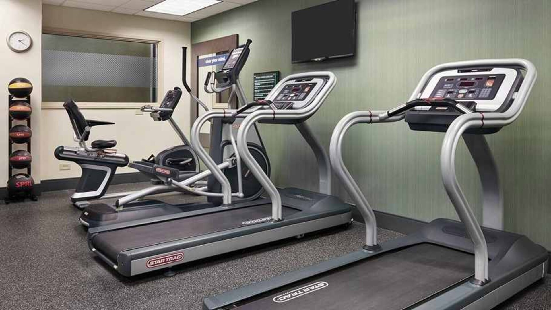 Well-equipped fitness center at Hampton Inn Chicago-Midway Airport.