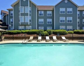 Large outdoor pool with tanning beds and seating at Homewood Suites by Hilton Atlanta-Galleria/Cumberland.