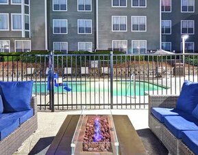 Comfortable outdoor lounge for relaxing and coworking around the pool at Homewood Suites by Hilton Atlanta-Galleria/Cumberland.