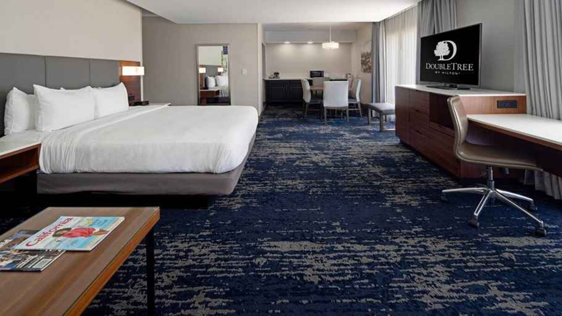 Spacious king suite with work desk and lounge area at DoubleTree by Hilton Hotel Bakersfield.