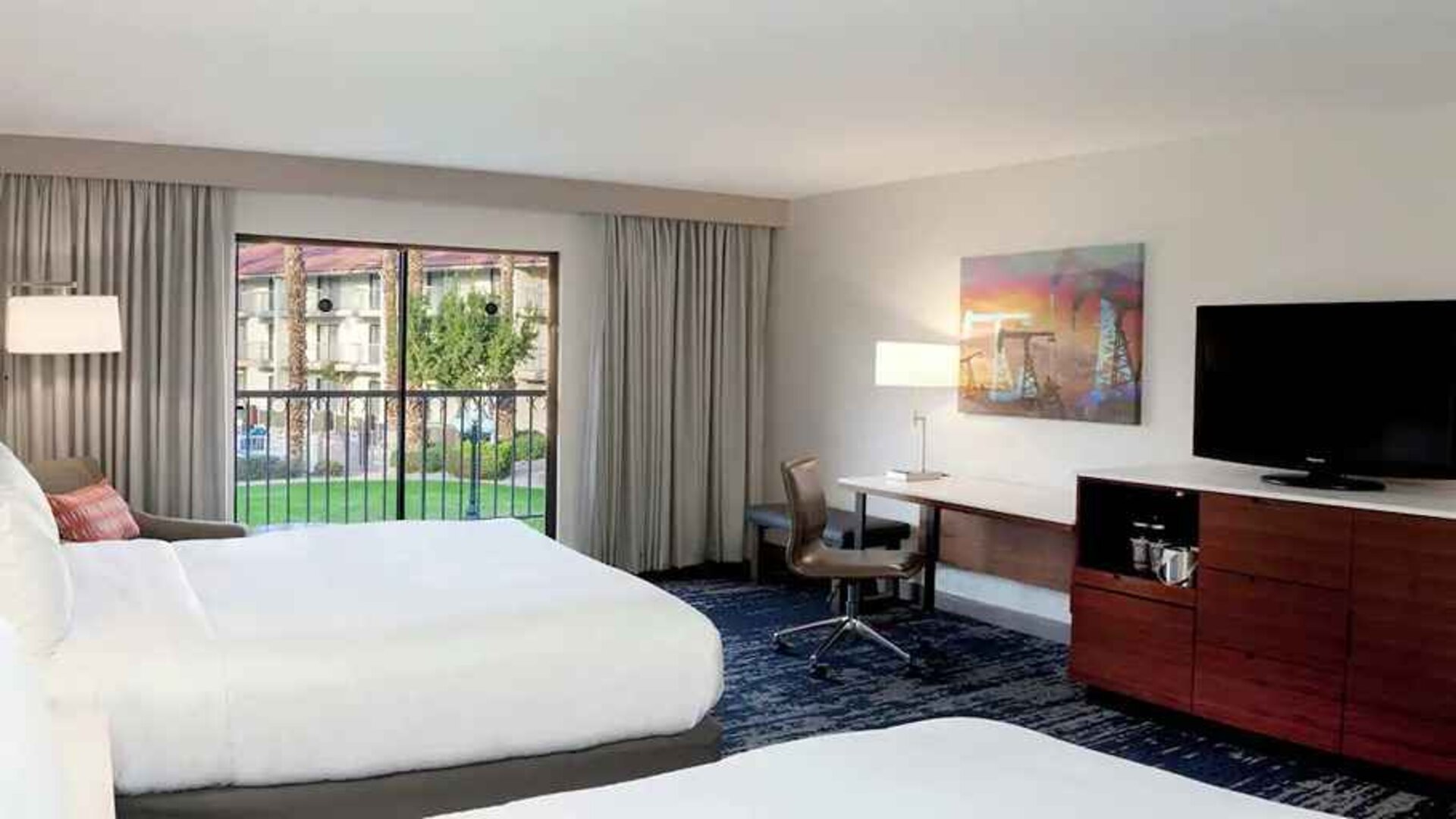 Gorgeous queen room with natural light, TV, and work area at DoubleTree by Hilton Hotel Bakersfield.