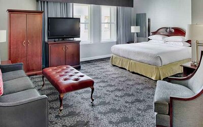 Spacious king studio with sofa and window at the Embassy Suites by Hilton Portland-Downtown.