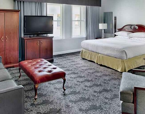 Spacious king studio with sofa and window at the Embassy Suites by Hilton Portland-Downtown.