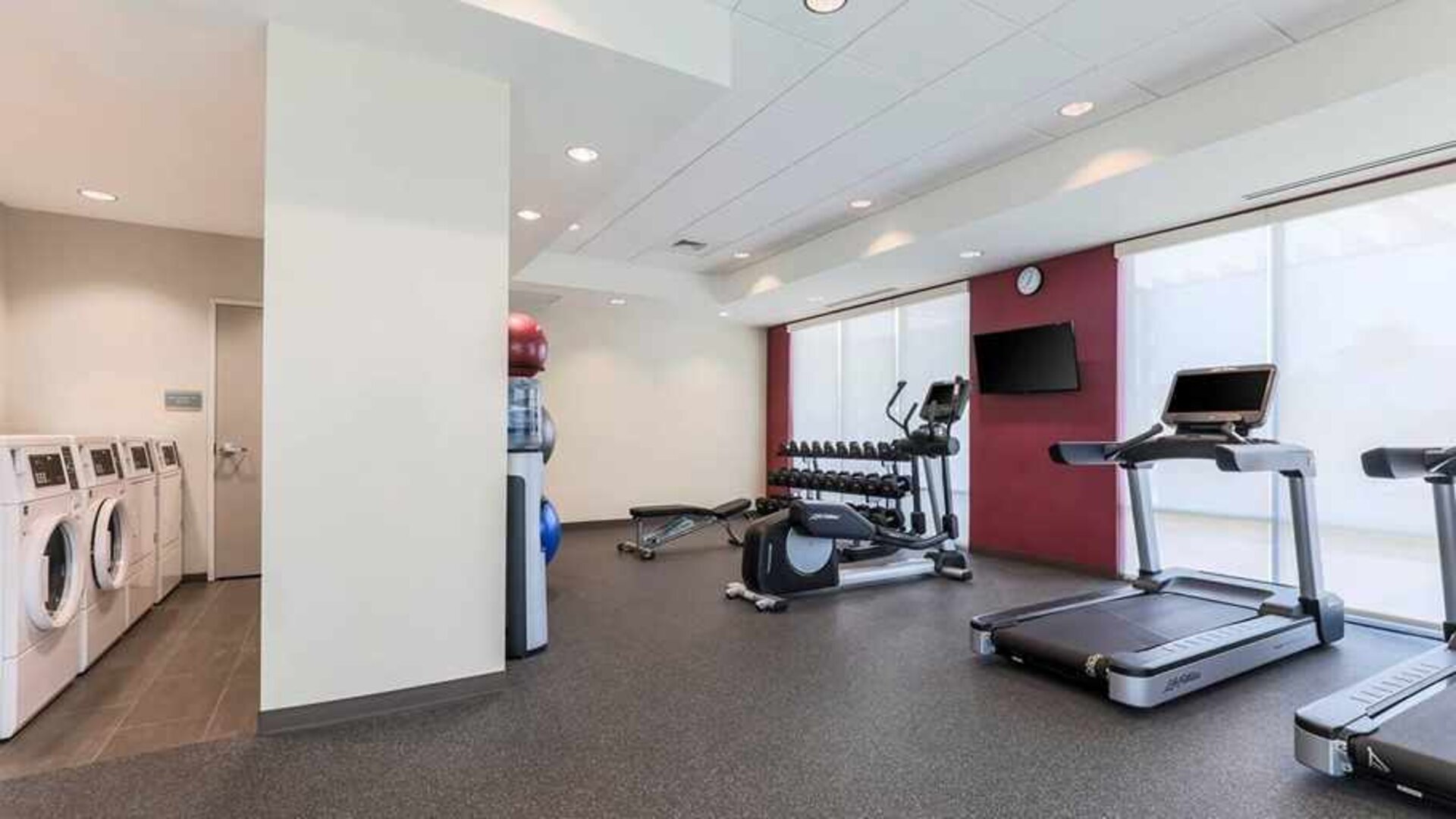 well-equipped fitness center with natural light at Home2 Suites by Hilton West Sacramento.