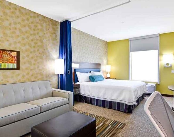 Luxurious king suite with lounge, TV, and work area at Home2 Suites by Hilton Fort Worth Southwest Cityview.