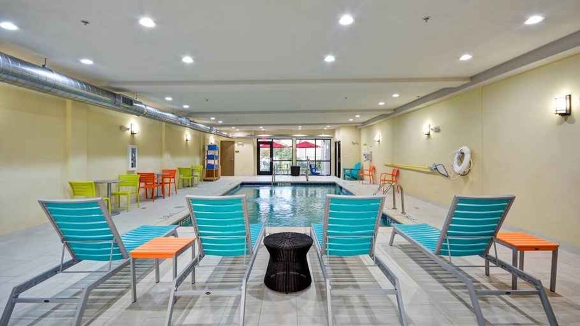 Relaxing indoor pool with seating area at Home2 Suites by Hilton Fort Worth Southwest Cityview.