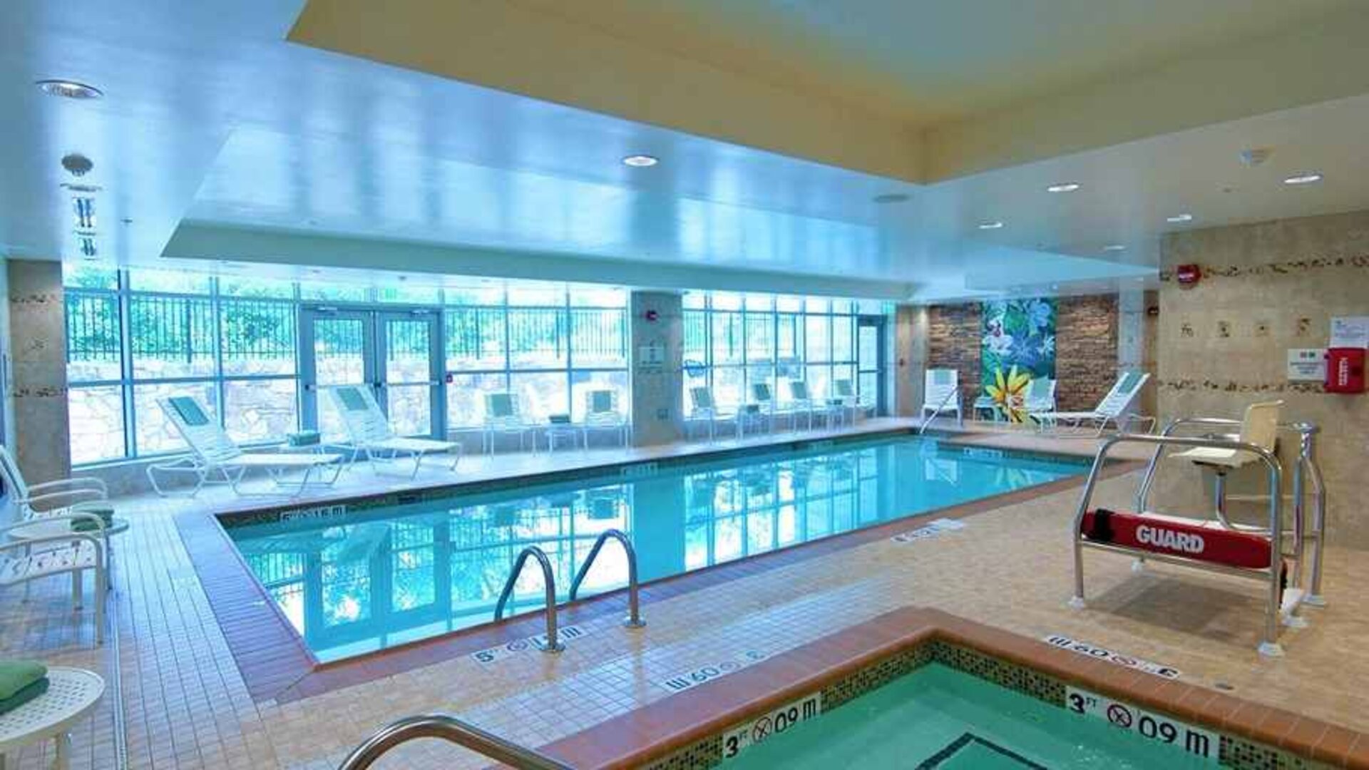 beautiful indoor pool with seating at Homewood Suites by Hilton Rockville-Gaithersburg.