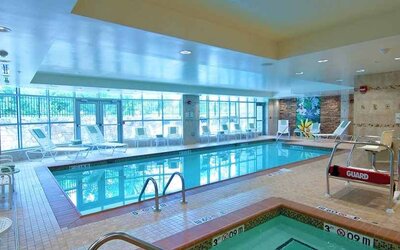 beautiful indoor pool with seating at Homewood Suites by Hilton Rockville-Gaithersburg.