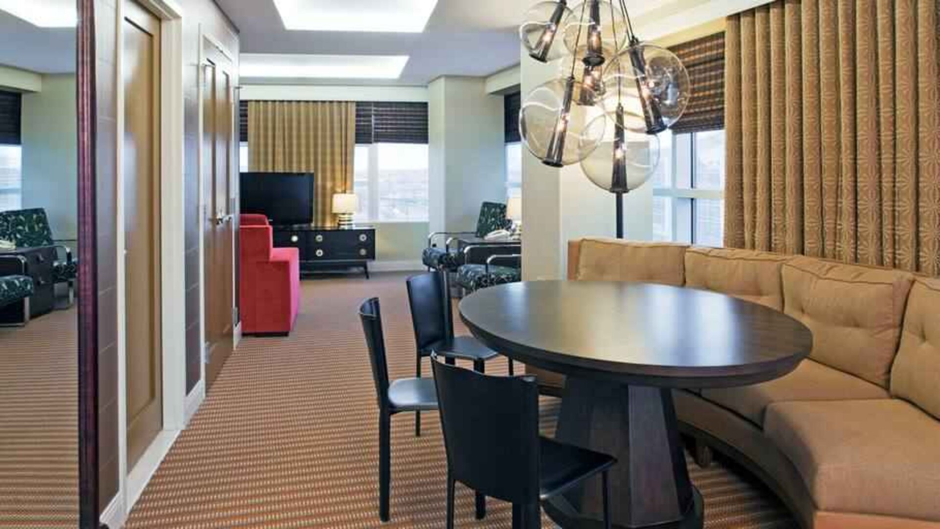 Living room with working station in a hotel suite at the Hilton Omaha.