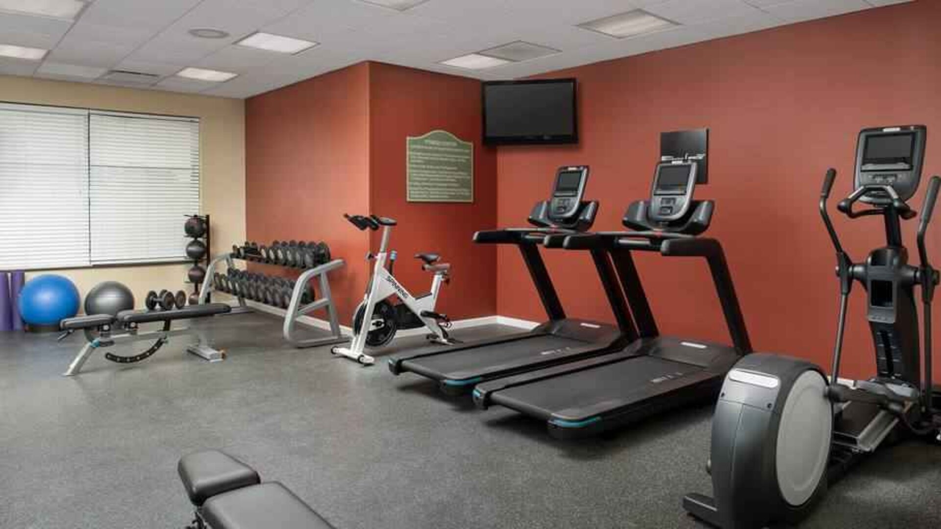 Fitness center with treadmills and weights at the Hilton Garden Inn Dallas/Duncanville.