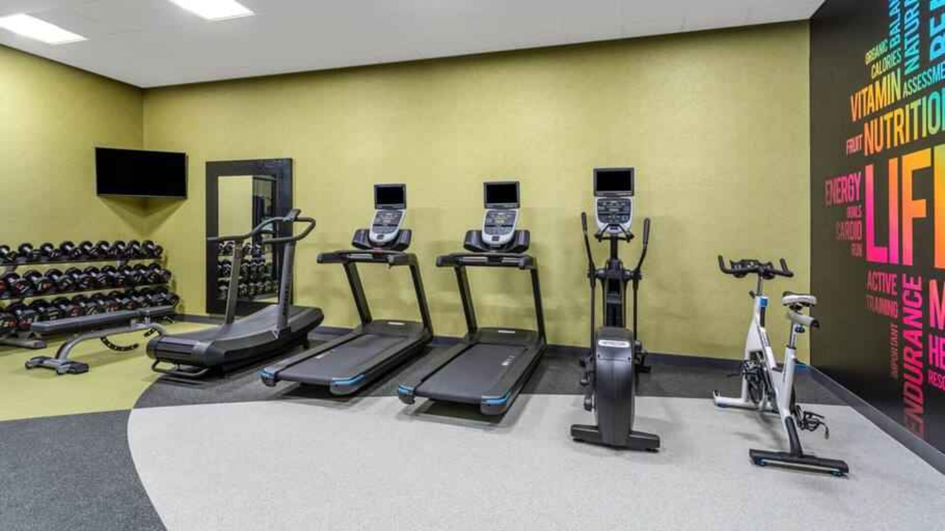 Fitness center with treadmills and weights at the Hilton Garden Inn Hays.