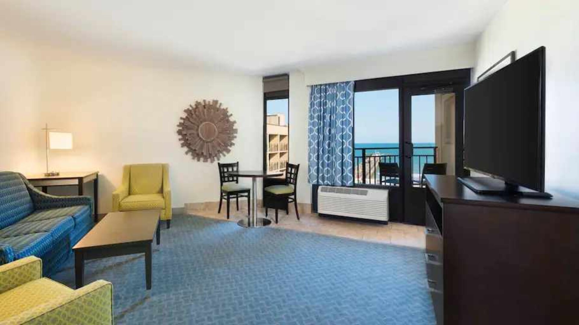 Living area with working station in a king suite at the DoubleTree by Hilton Myrtle Beach.