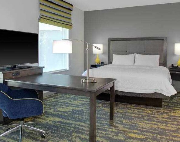 Working station in a king bedroom at the Hampton Inn & Suites by Hilton-Irvine/Orange County Airport.