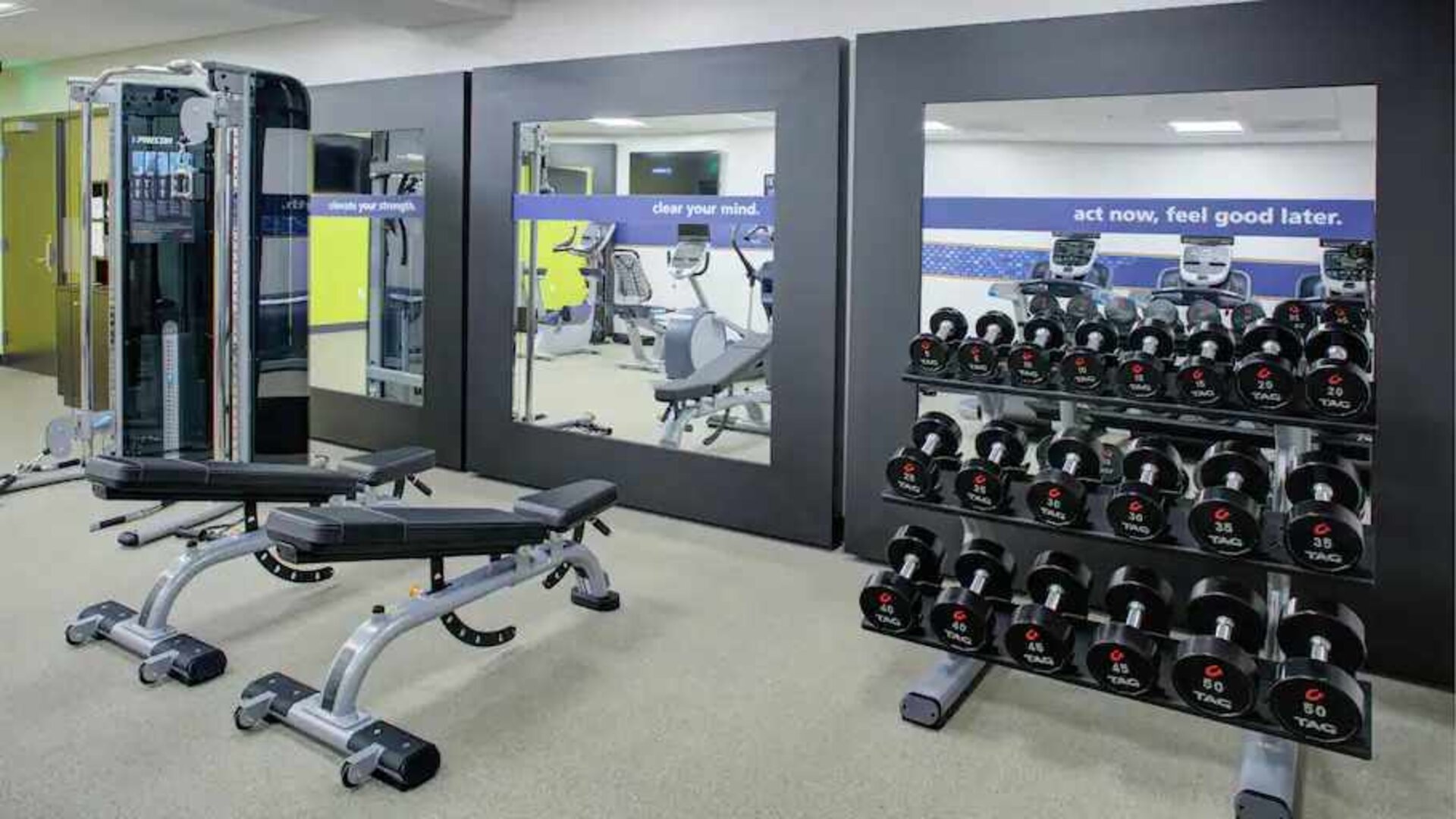 Fitness center with weights at the Hampton Inn & Suites by Hilton-Irvine/Orange County Airport.