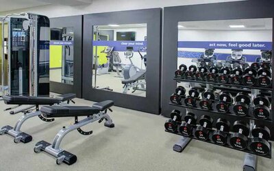 Fitness center with weights at the Hampton Inn & Suites by Hilton-Irvine/Orange County Airport.