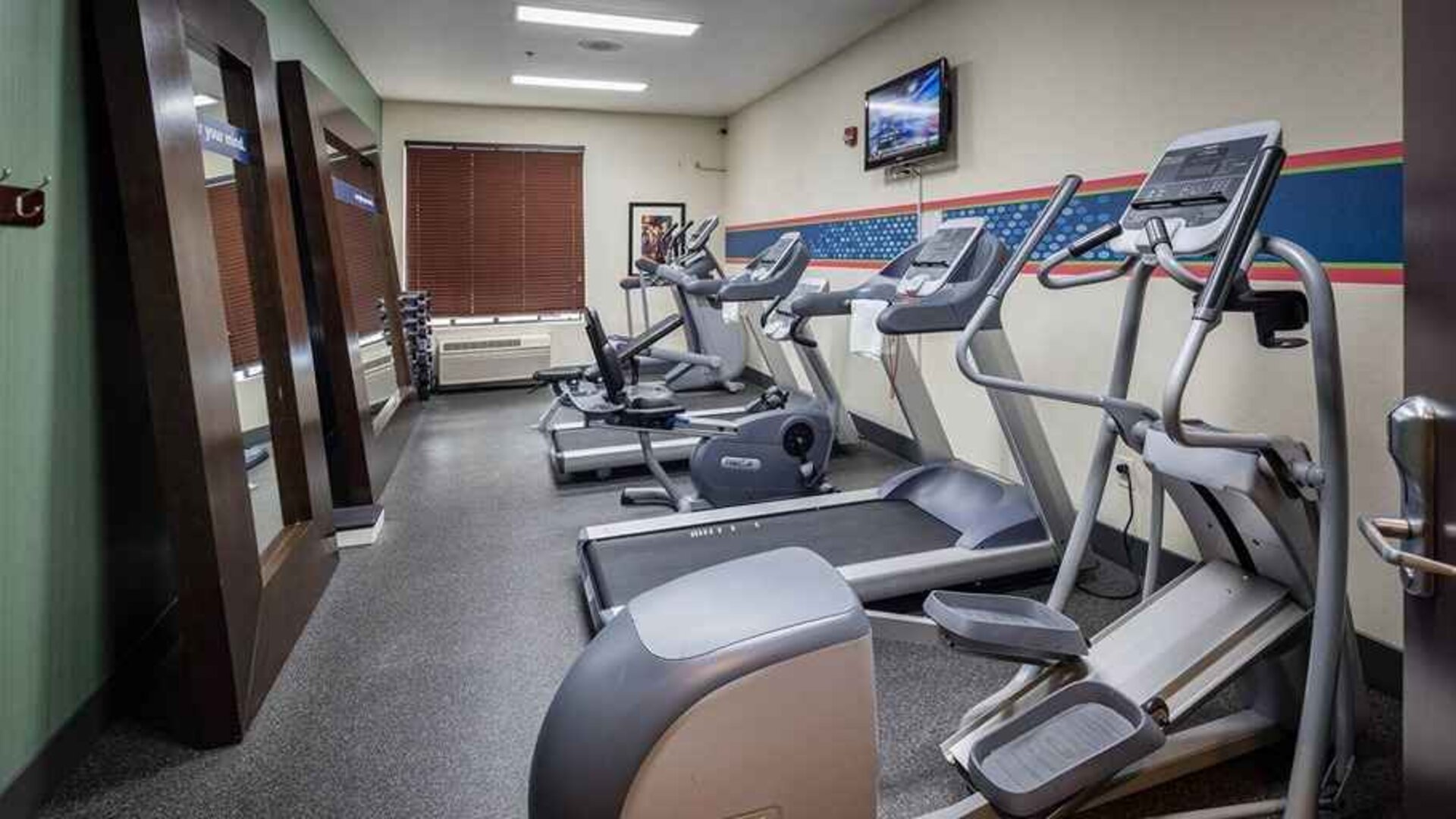 Well-equipped fitness center at Hampton Inn San Francisco Airport.
