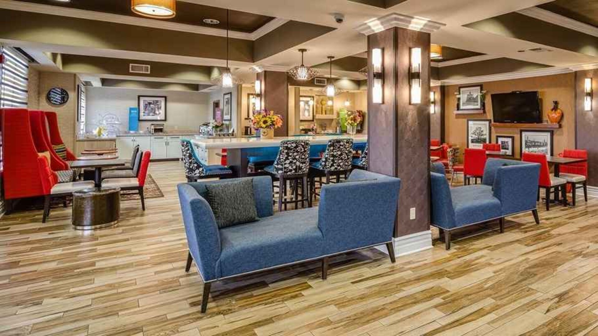 Colorful lobby and coworking space at Hampton Inn San Francisco Airport.