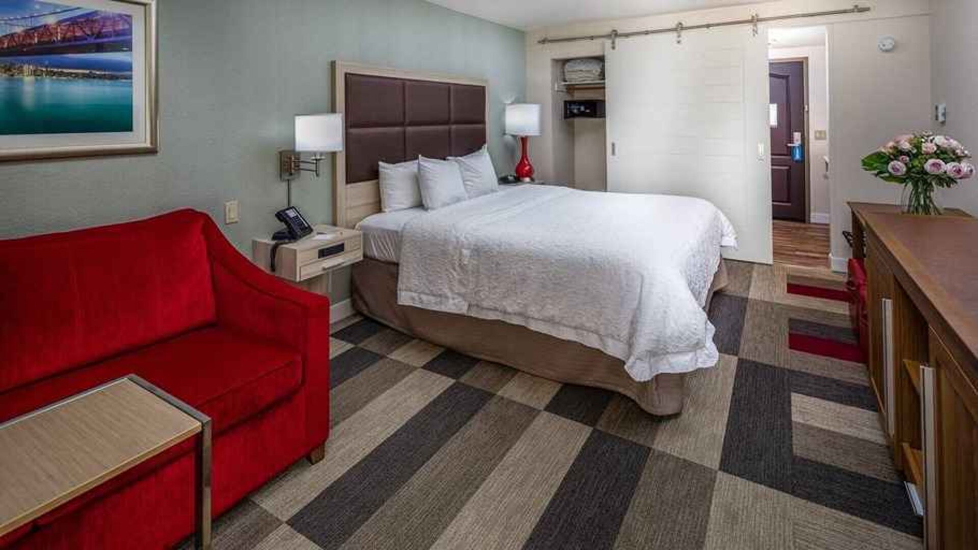 Colorful king suite with natural light at Hampton Inn San Francisco Airport.