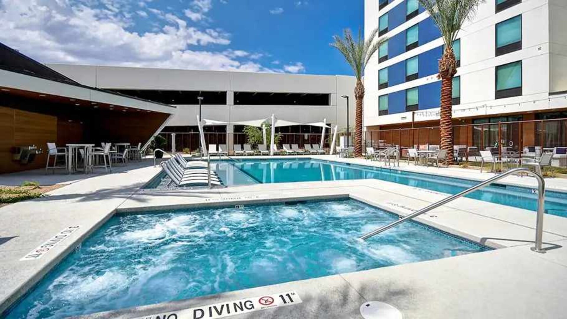 beautiful outdoor pool with seating and sun beds at Home2 Suites by Hilton Las Vegas Convention Center.