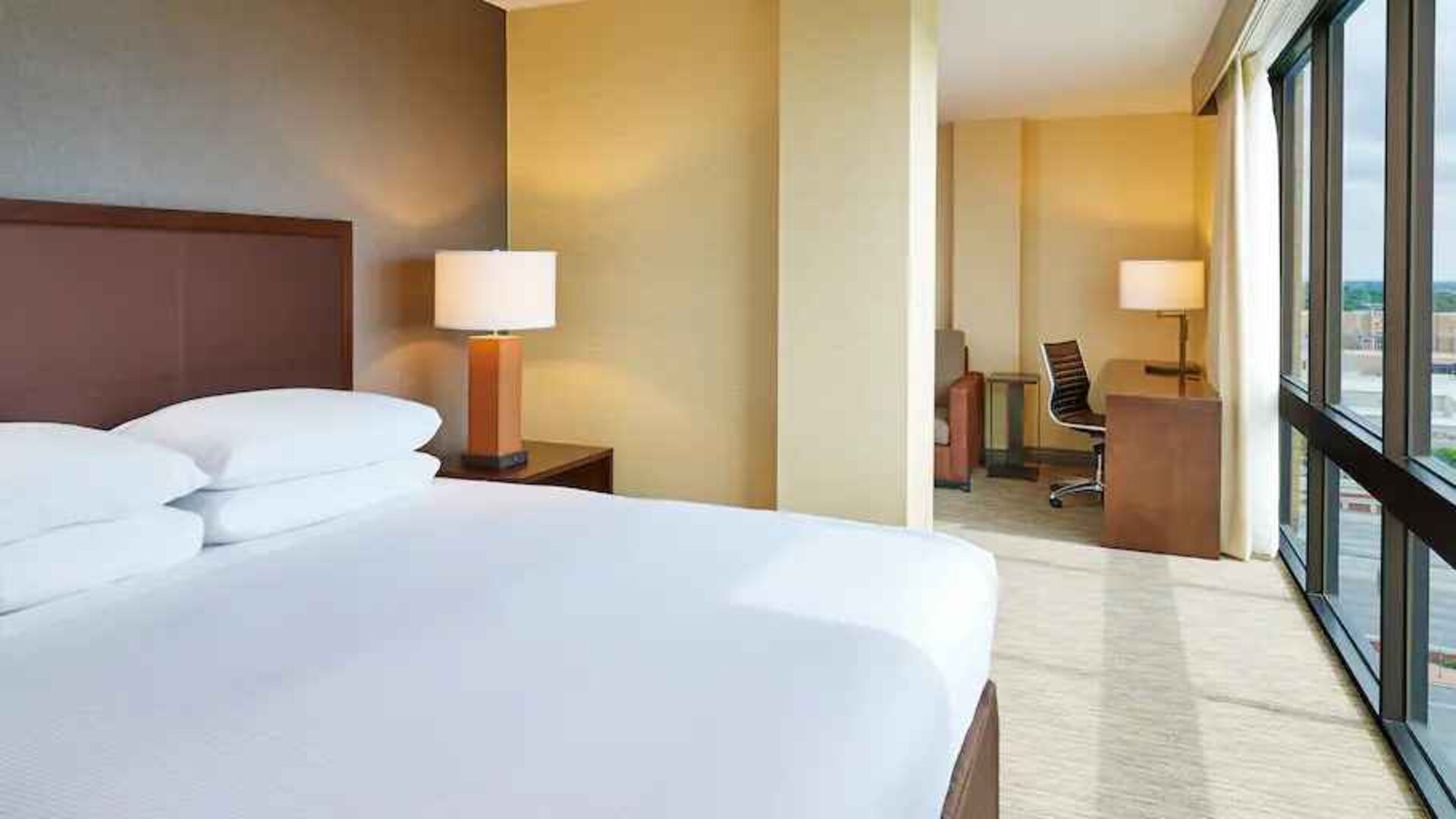 King suite with windows and working station at the Hilton San Antonio-Airport.